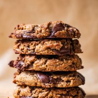 A stack of five large chocolate chip cookies.