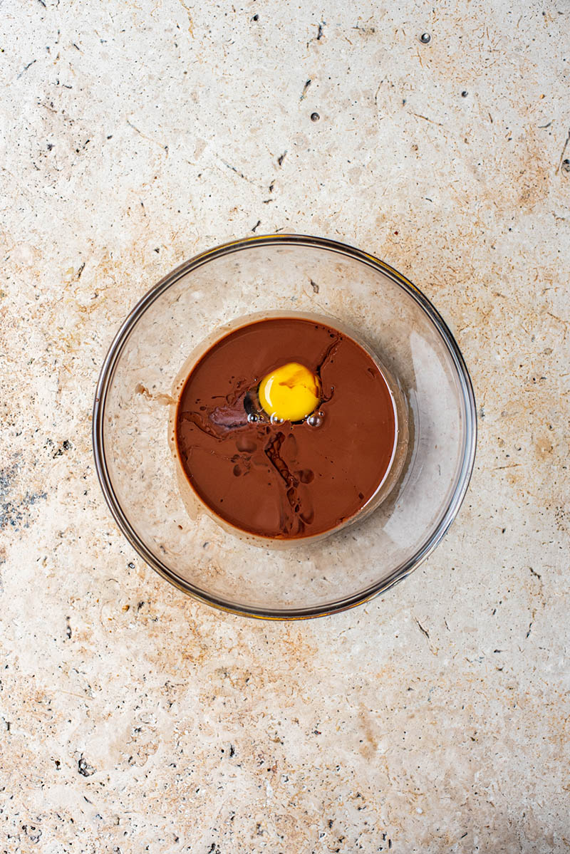 Chocolate mixture with egg in a bowl.