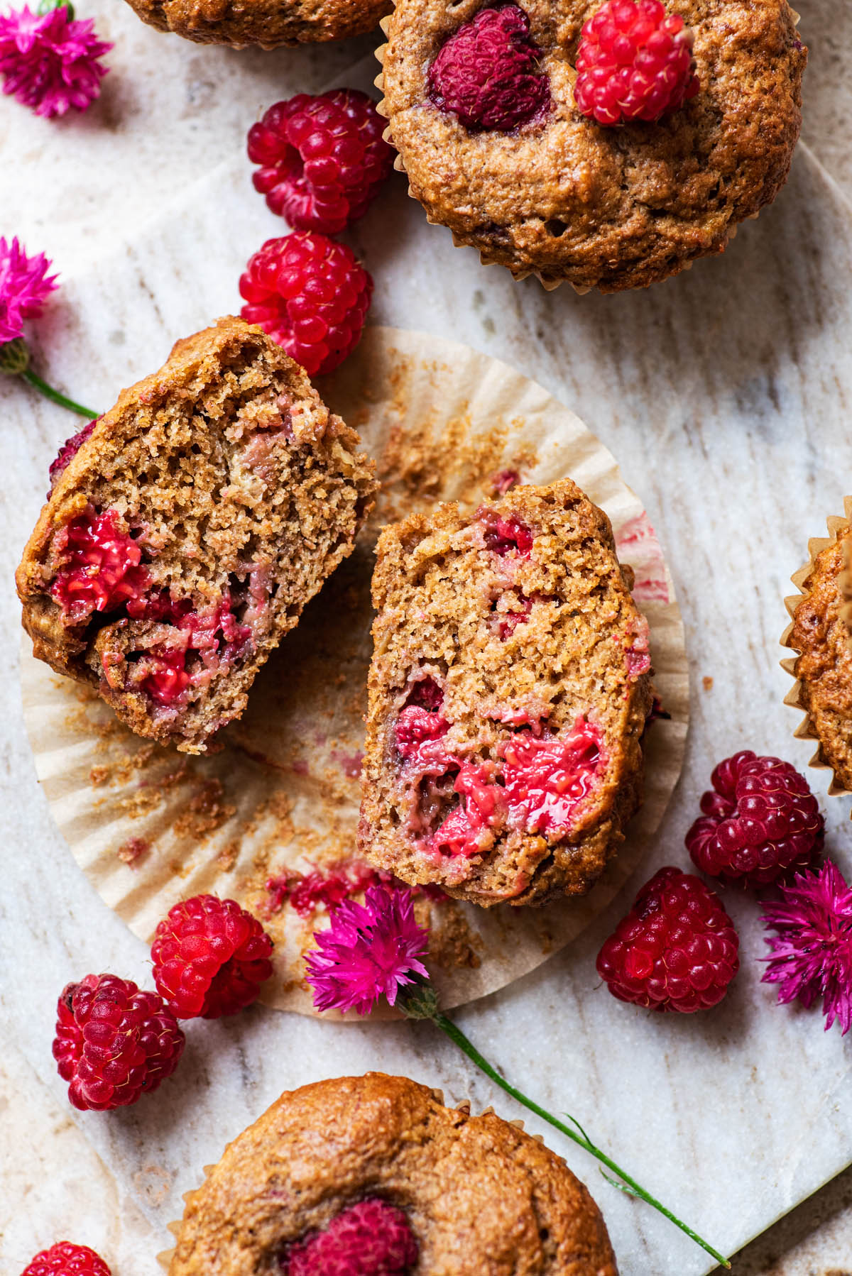 A raspberry muffin cut in half to show interior texture.