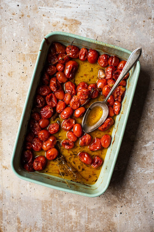 Confit in the baking dish, about half removed, with a large silver spoon.