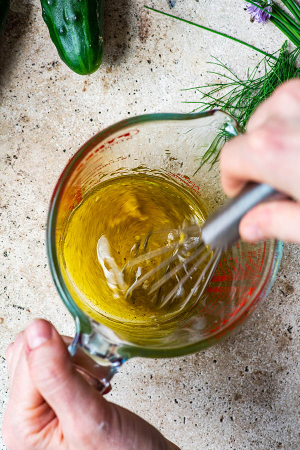 Whisking the vinaigrette in a pyrex glass.