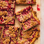 Plum streusel cake cut into squares, top down view.