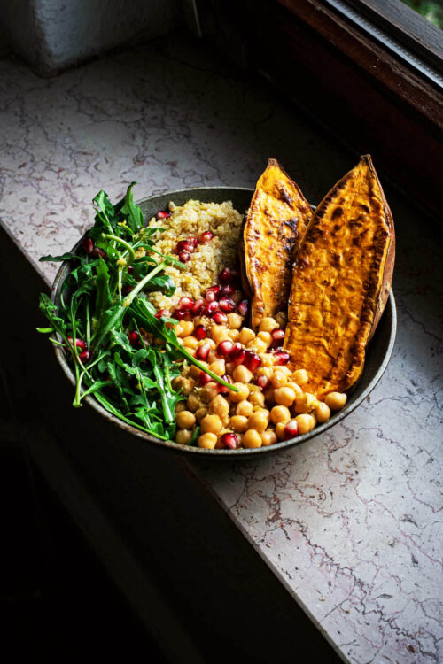 A roasted sweet potato bowl with quinoa, chickpeas, and greens.