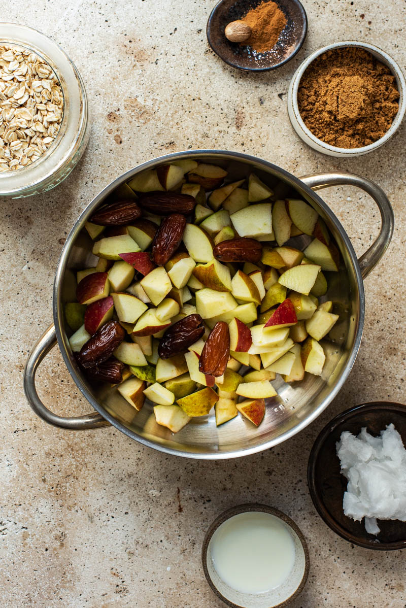 Apples and dates in a pot before cooking.
