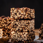 A stack of puffed wheat squares with more bars around.
