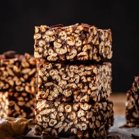A stack of puffed wheat squares with more bars around.