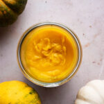 Top down view of pumpkin puree in a jar.