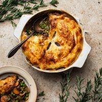 Mushroom pot pie with a serving on a separate plate.