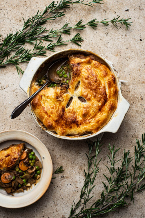 Mushroom pot pie with a serving on a separate plate.