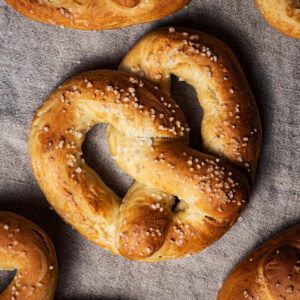 Baked pretzels on a natural linen cloth.