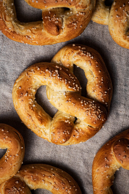 Baked pretzels on a natural linen cloth.