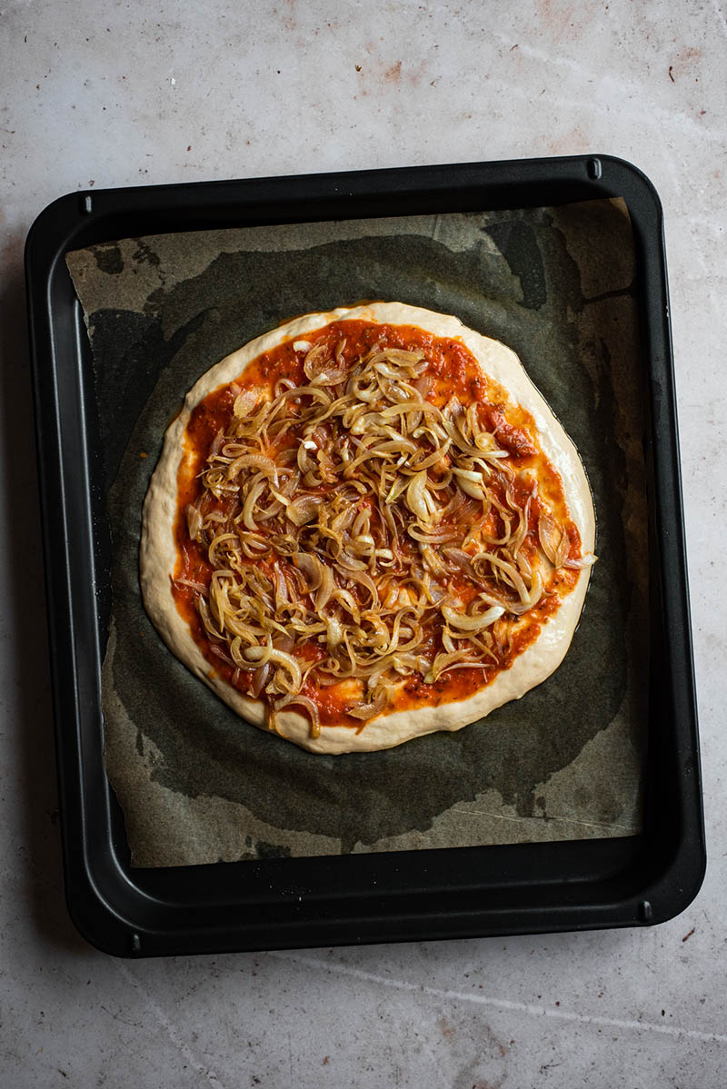 Caramelised onions added to the pizza.