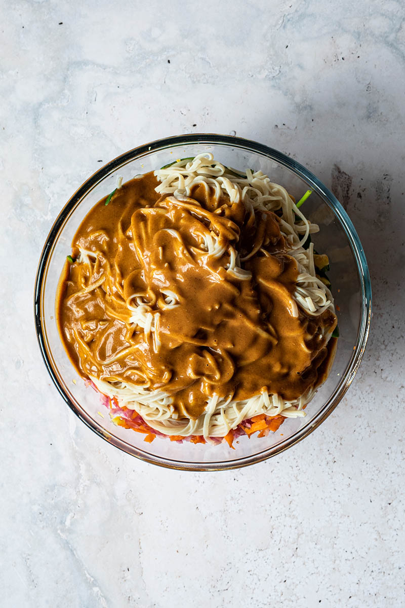 Peanut butter sauce poured over rice noodles.