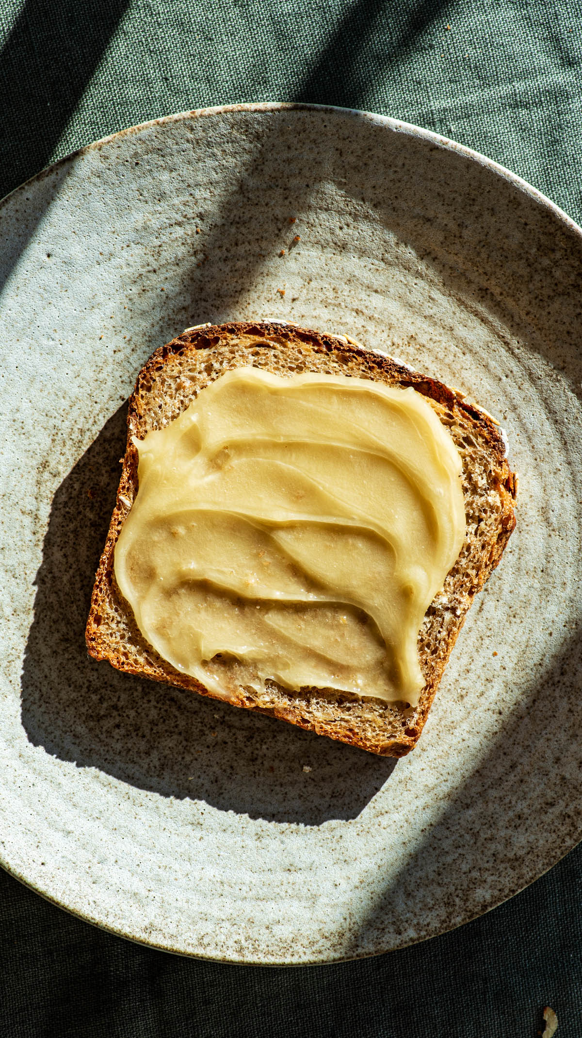 Slice of bread on a plate with honey.