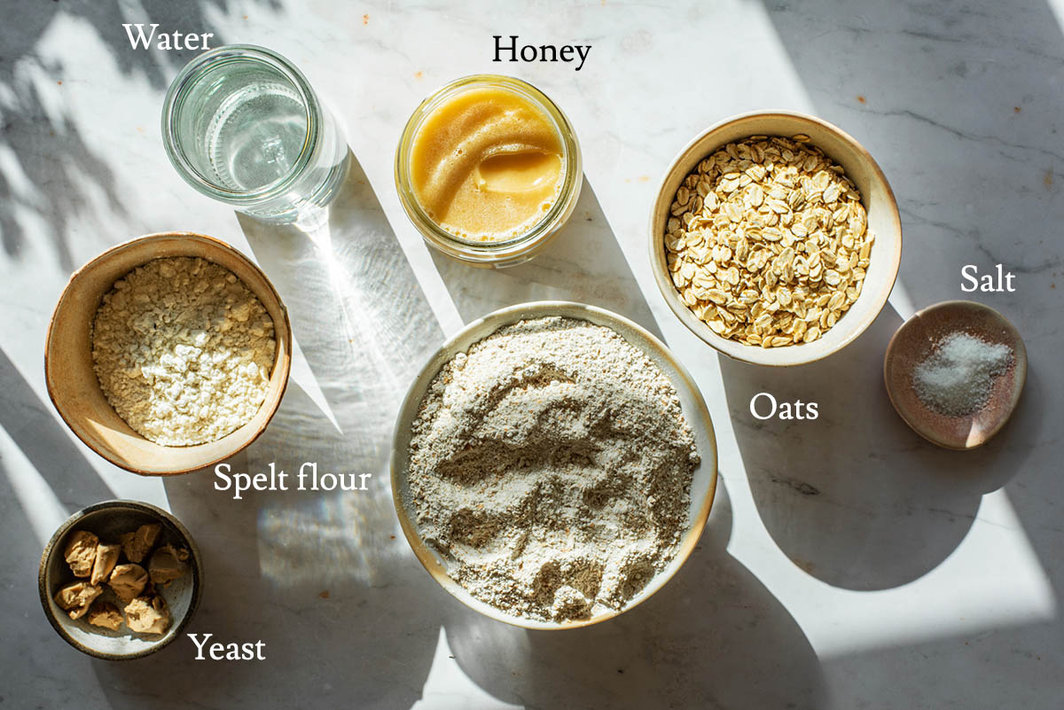 Honey oat bread ingredients with labels.