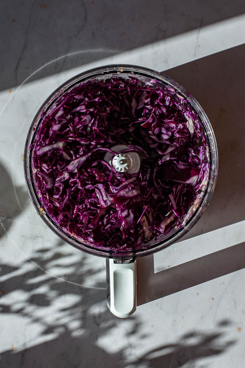Red and white cabbage thinly sliced in a food processor.