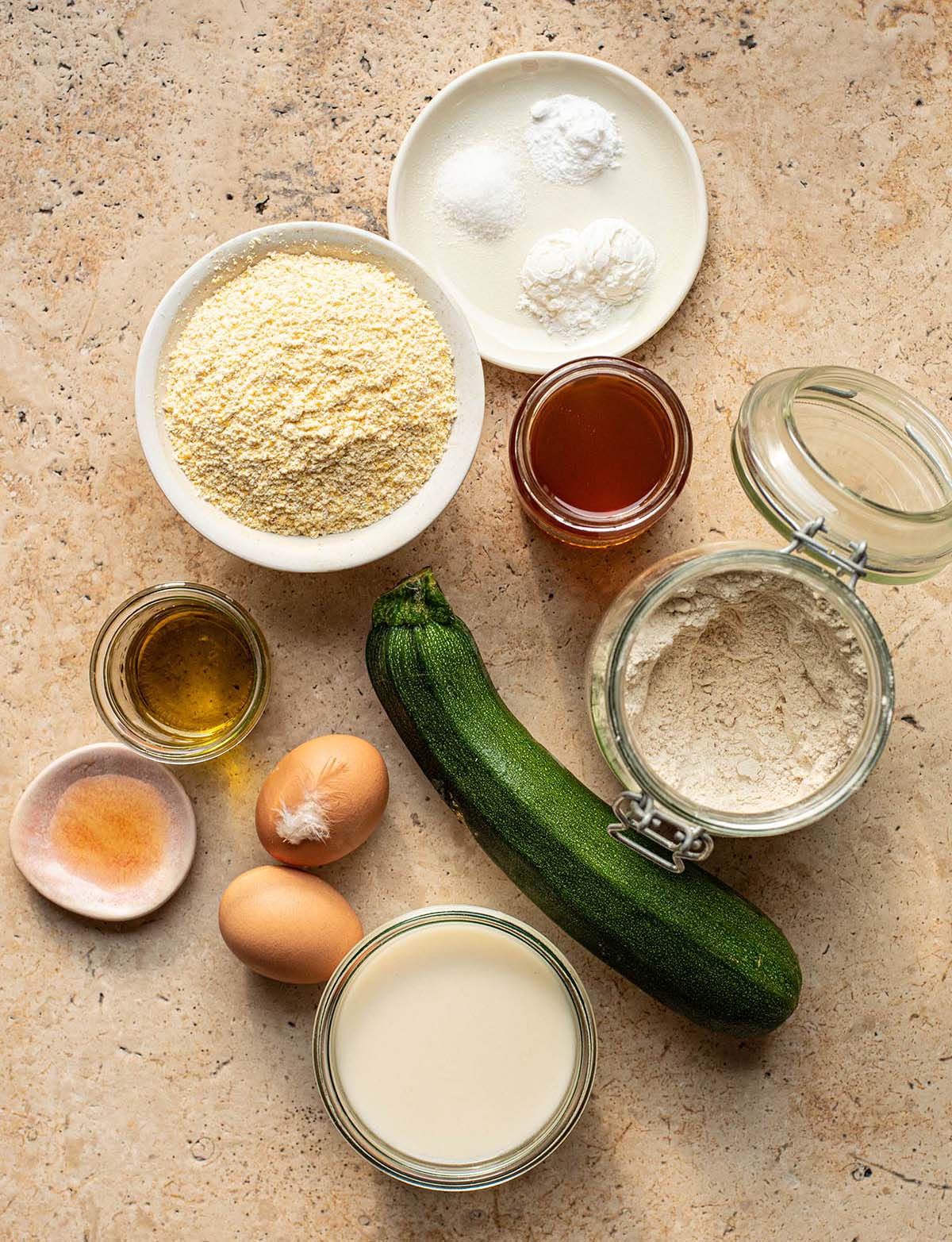 Dairy free zucchini cornbread muffin ingredients in a flay lay.