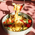 Pasta with vegetables in a deep plate.