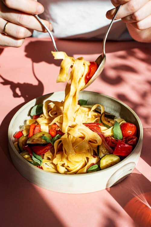 Pasta with vegetables in a deep plate.