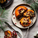 Three rice-stuffed pumpkins on plates.