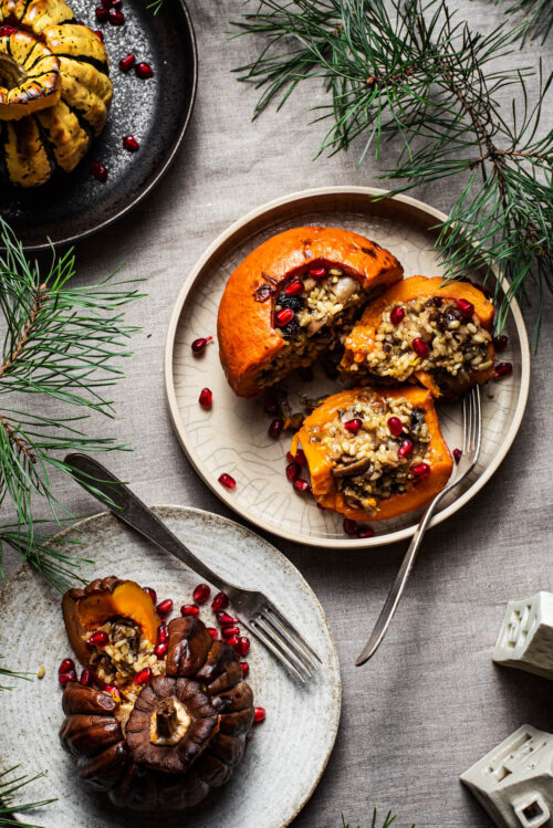 Three rice-stuffed pumpkins on plates.
