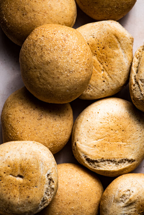 A pile of golden buns, close up.