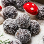 Chocolate balls in coconut with holiday decorations.