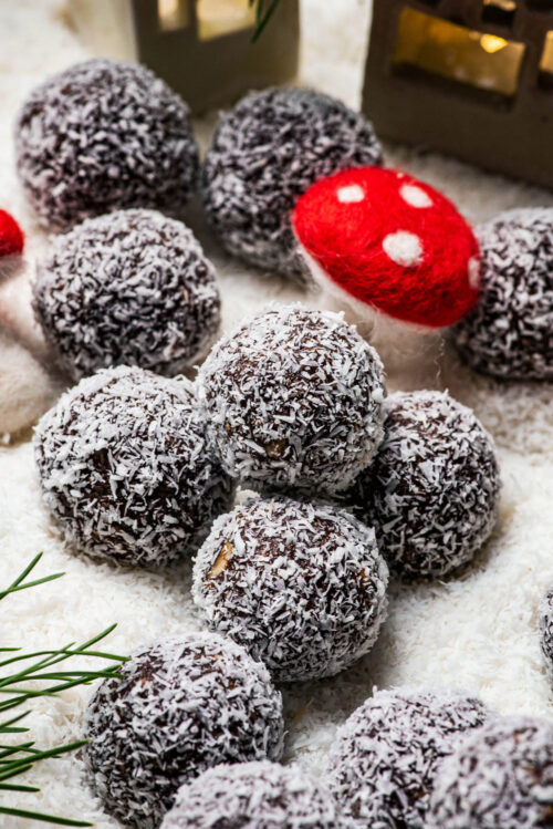 Chocolate balls in coconut with holiday decorations.