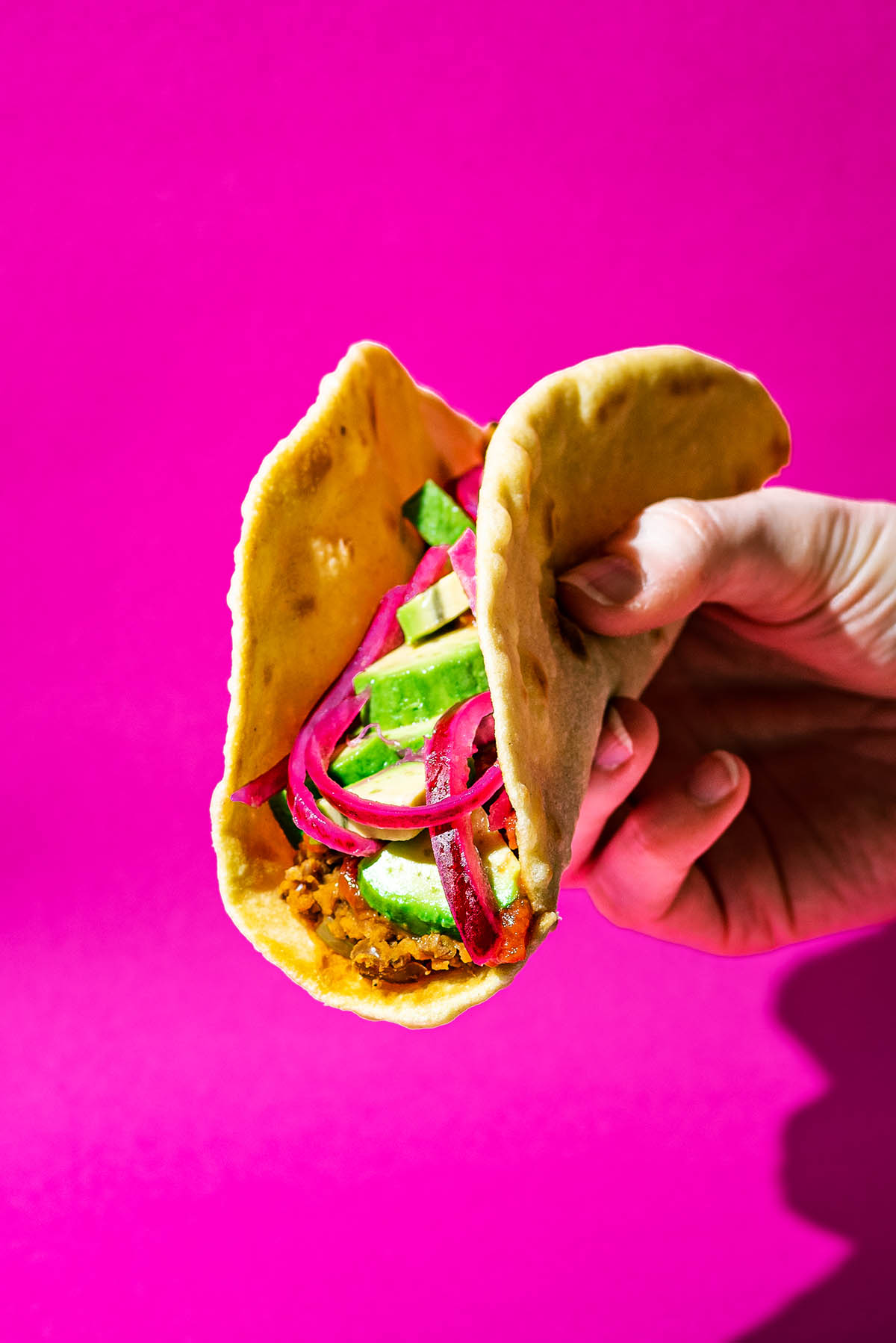 Filled tortilla with refried beans, pickled onion, and avocado.