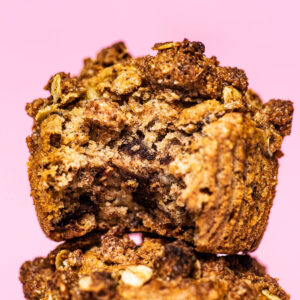 Close up of two muffins, stacked, with a bite taken out of the top muffin.
