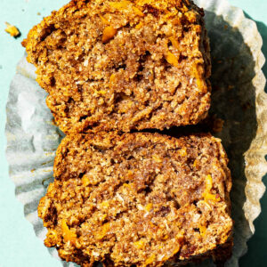 A carrot muffin close up, halved to show interior texture.