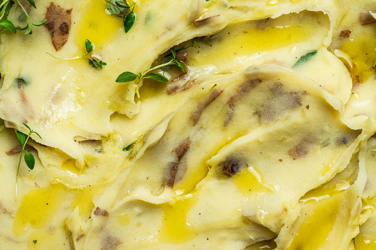 Close up of dairy-free mashed potatoes with thyme and olive oil.