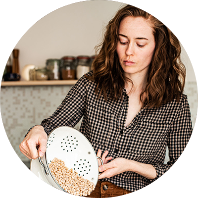 The author pouring chickpeas from a colander.