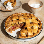 Apple pie three-quarters view, with a slice removed to show the filling.