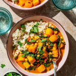 Top-down view of a winter squash curry in bowls with rice.