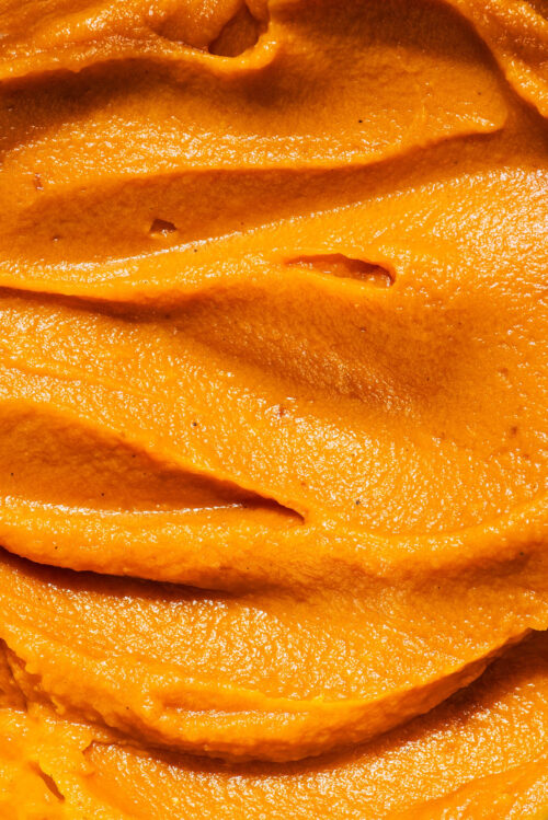 Close up of swirled pureed sweet potato.