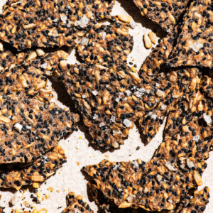 Seed crackers close up, scattered on a light background.