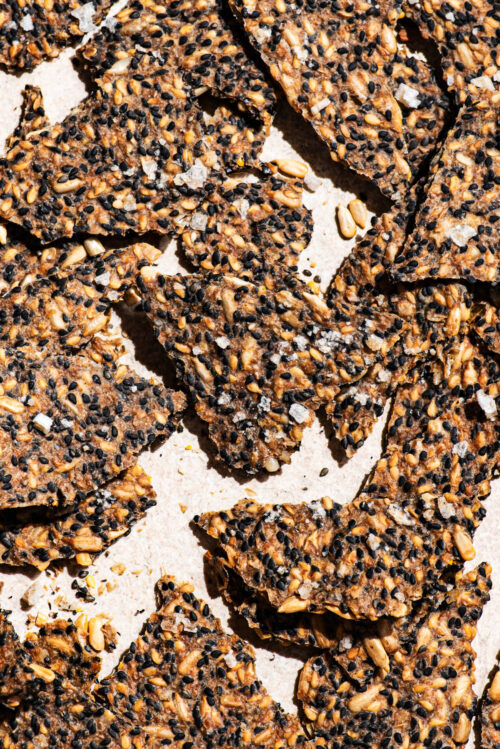 Seed crackers close up, scattered on a light background.