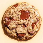 Close up of a chocolate chunk cookie in bright light.