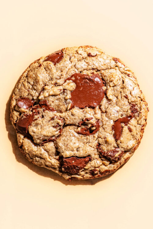 Close up of a chocolate chunk cookie in bright light.