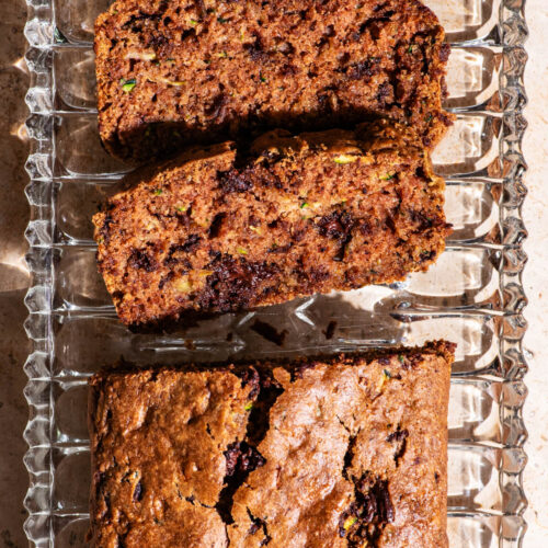Top-down view of a zucchini loaf with two slices cut.