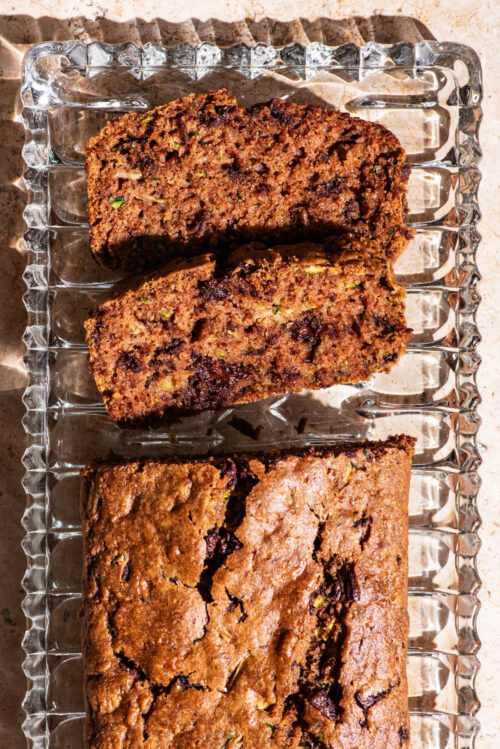Top-down view of a zucchini loaf with two slices cut.
