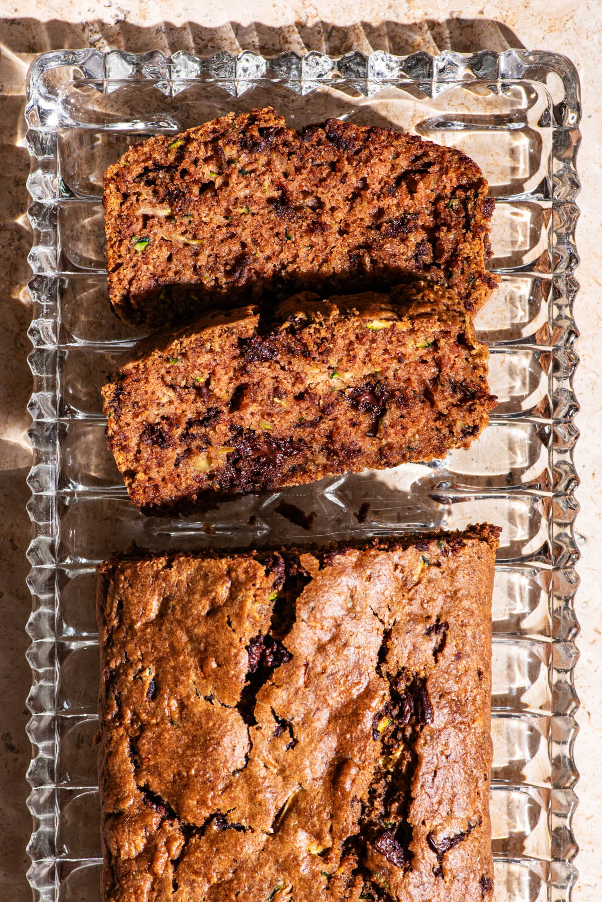 Top-down view of a zucchini loaf with two slices cut.