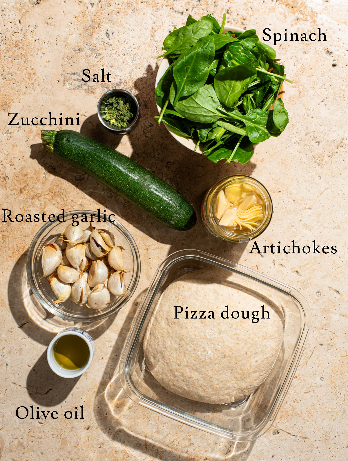 Spinach artichoke pizza ingredients with labels.