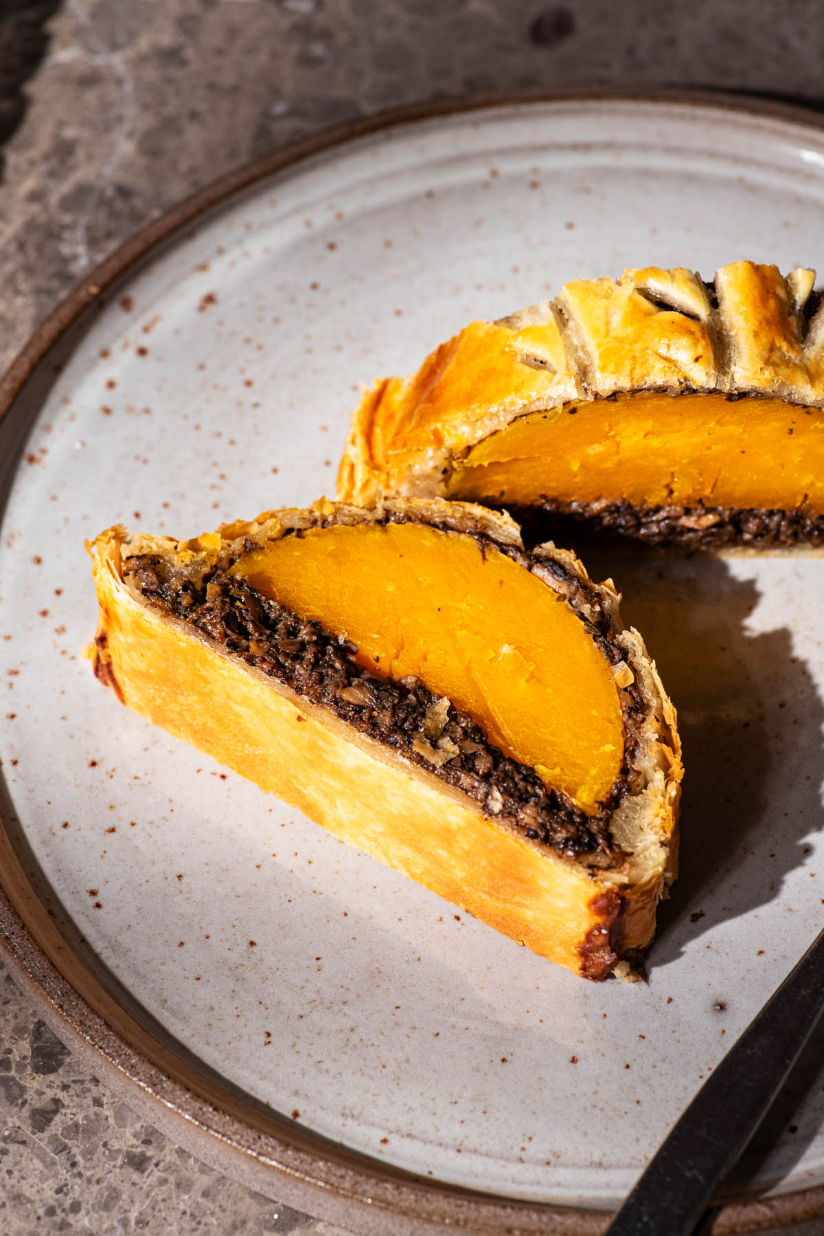 Close up of a vegetable wellington on a plate.