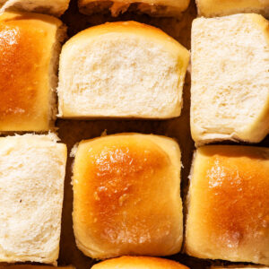Dinner rolls arranged together to show all sides of the buns.