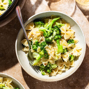Bowls of farfalle with broccoli.