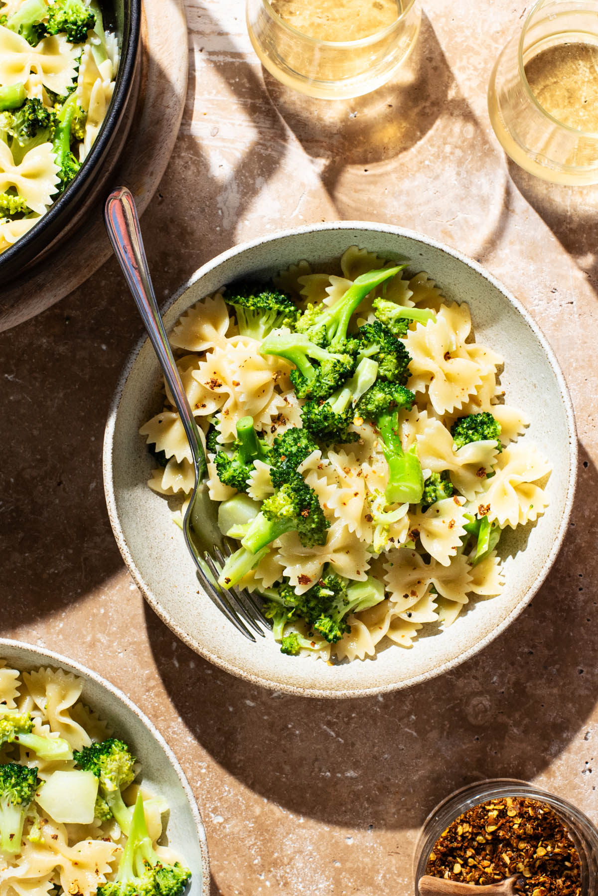 Bowls of farfalle with broccoli.