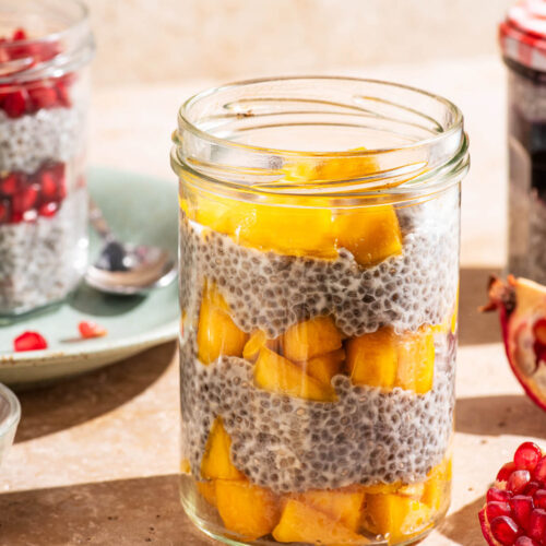 Layered chia pudding in jars with fruit.
