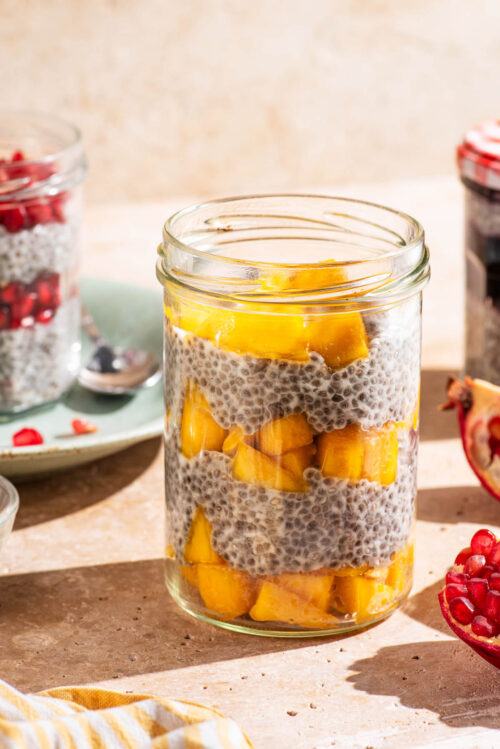 Layered chia pudding in jars with fruit.